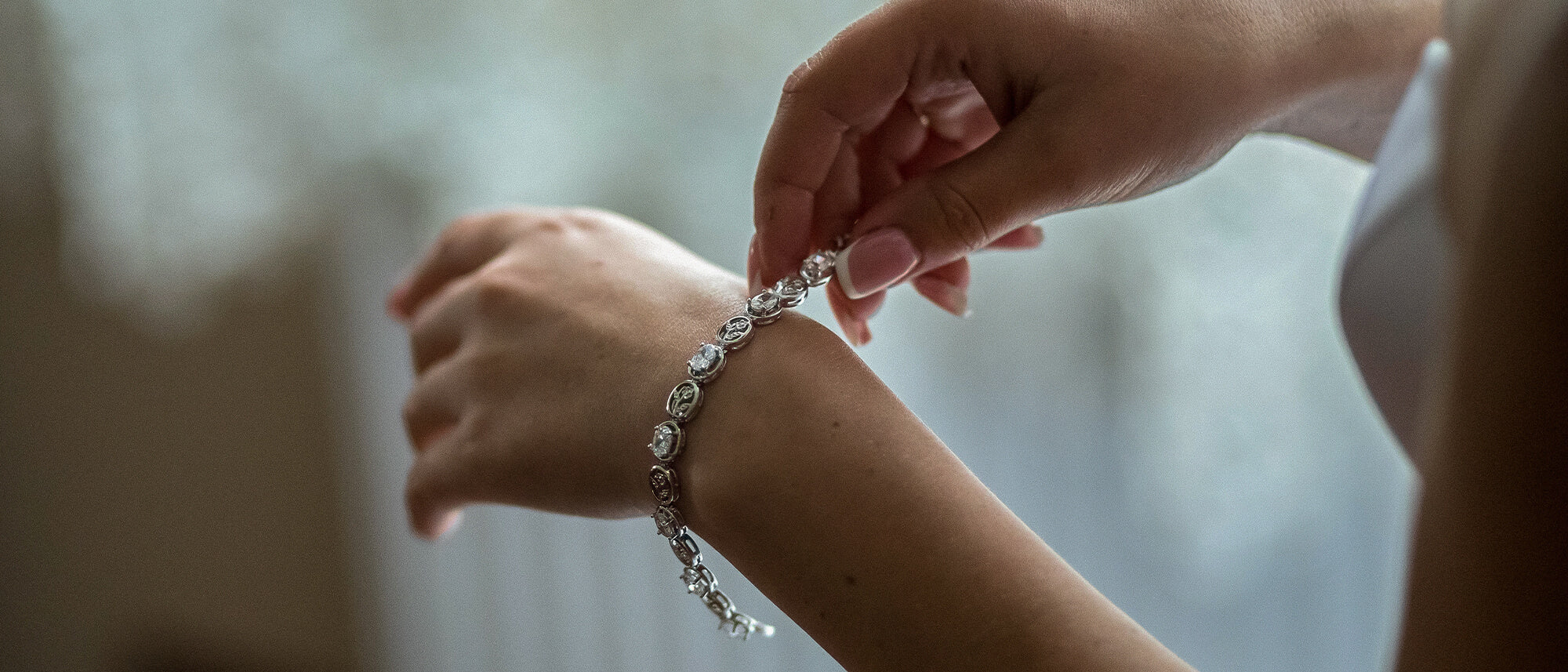 Woman in putting bracelet on hand